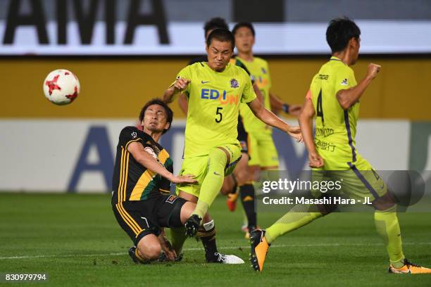Kazuhiko Chiba of Sanfrecce Hiroshima and Hiroaki Okuno of Vegalta Sendai compete for the ball during the J.League J1 match between Vegalta Sendai...