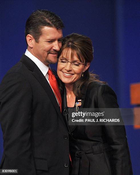 Republican Sarah Palin is embraced by husband Todd Palin following her vice presidential debate with Democrat Joseph Biden October 2, 2008 at...