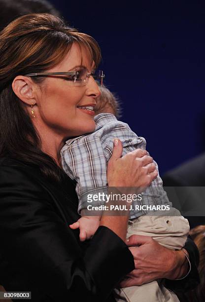 Republican Sarah Palin holds her infant son Trig following her vice presidential debate with Democrat Joseph Biden October 2, 2008 at Washington...