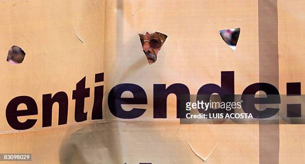Survivor of the student massacre of Tlatelolco is seen through a banner as he marches during its 40th anniversary, in Mexico City, on October 2,...