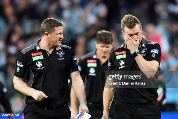 Magpies midfield coach Scott Burns chats with Magpies head coach Nathan Buckley during the round 21 AFL match between Port Adelaide Power and the...