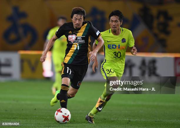 Naoki Ishihara of Vegalta Sendai and Kosei Shibasaki of Sanfrecce Hiroshima compete for the ball during the J.League J1 match between Vegalta Sendai...