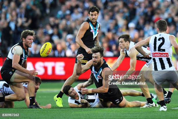Charlie Dixon of the Power handballs during the round 21 AFL match between Port Adelaide Power and the Collingwood Magpies at Adelaide Oval on August...