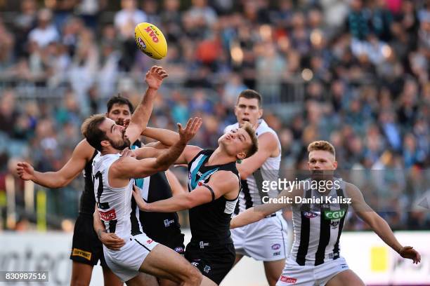 Steele Sidebottom of the Magpies and Ollie Wines of the Power compete for the ball during the round 21 AFL match between Port Adelaide Power and the...