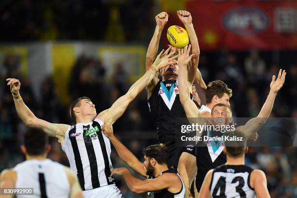 Players compete for the ball during the round 21 AFL match between Port Adelaide Power and the Collingwood Magpies at Adelaide Oval on August 13,...