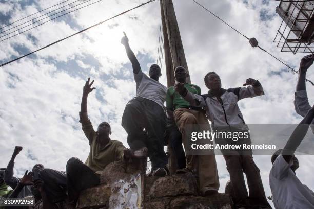 Supporters cheer as opposition candidate Raila Odinga addresses a crowd in the Kibera slum on August 13, 2017 in Nairobi, Kenya. A day prior,...
