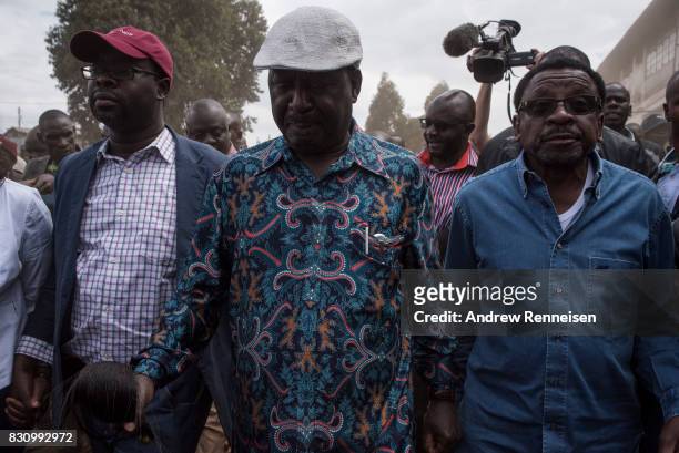 Opposition candidate Raila Odinga walks to address his supporters in the Kibera slum on August 13, 2017 in Nairobi, Kenya. A day prior,...