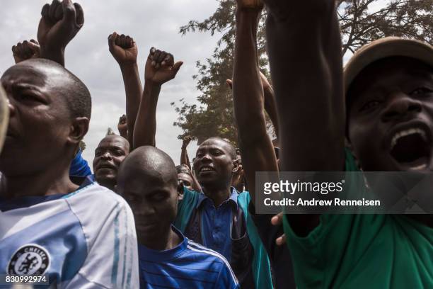 Supporters cheer as Opposition candidate Raila Odinga addresses a crowd in the Kibera slum on August 13, 2017 in Nairobi, Kenya. A day prior,...