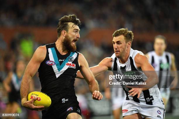 Charlie Dixon of the Power runs with the ball during the round 21 AFL match between Port Adelaide Power and the Collingwood Magpies at Adelaide Oval...