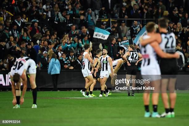 Magpies players look on dejected after being defeated by the Power during the round 21 AFL match between Port Adelaide Power and the Collingwood...