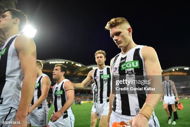 Adam Treloar of the Magpies walks from the field looking dejected after being defeated by the Power during the round 21 AFL match between Port...