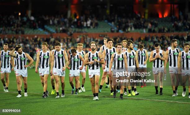 Alex Fasolo of the Magpies leads his team mates from the field after being defeated by the Power during the round 21 AFL match between Port Adelaide...