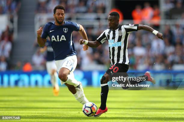 Christian Atsu of Newcastle United attempts to get past Mousa Dembele of Tottenham Hotspur during the Premier League match between Newcastle United...