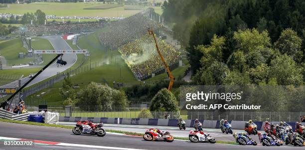 Jorge Lorenzo of Spain , Marc Marquez of Spain , Andrea Dovizioso of Italy and Valentino Rossi of Italy race at the MotoGP Austrian Grand Prix race...