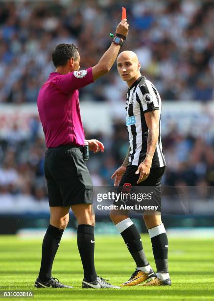 Referee Andre Marriner shows a red card to Jonjo Shelvey of Newcastle United during the Premier League match between Newcastle United and Tottenham...