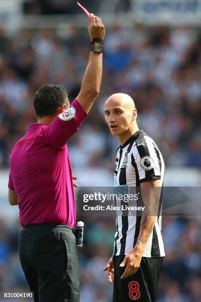 Referee Andre Marriner shows a red card to Jonjo Shelvey of Newcastle United during the Premier League match between Newcastle United and Tottenham...