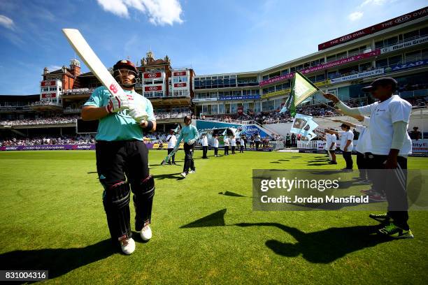 Aaron Finch and Jason Roy of Surrey make their way out to open the batting prior to the NatWest T20 Blast match between Surrey and Sussex Shark at...