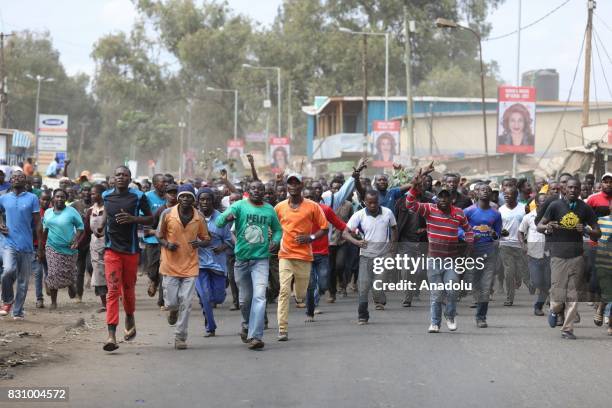 Supporters of Kenya's opposition leader Raila Odinga run to gathering to listen Odinga's speech in the Kibera slum on August 13, 2017 in Nairobi,...