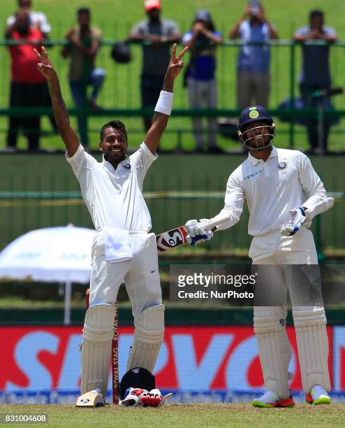 Indian cricketer Hardik Pandya celebrates after scoring 100 runs during the 2nd Day's play in the 3rd Test match between Sri Lanka and India at the...