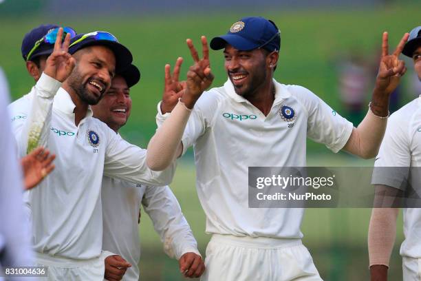 Indian cricketers Shikhar Dhawan and Hardik Pandya walk back to the pavilion after the play ended during the 2nd Day's play in the 3rd Test match...