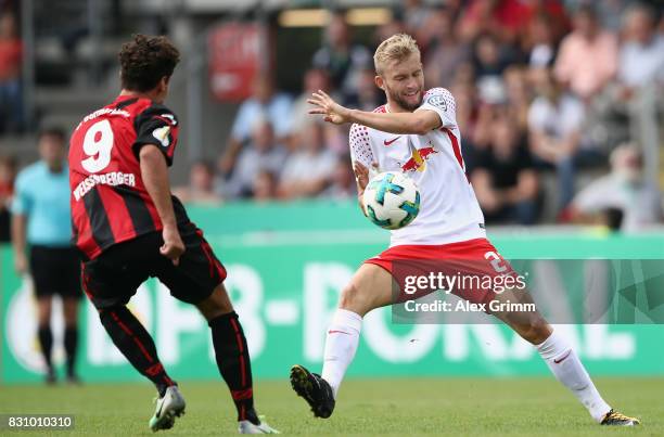 Konrad Laimer of Leipzig is challenged by Niklas Weissenberger of Dorfmerkingen during the DFB Cup first round match between Sportfreunde...
