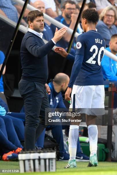 Dele Alli of Tottenham Hotspur embraces with Mauricio Pochettino, Manager of Tottenham Hotspur after he is subbed during the Premier League match...