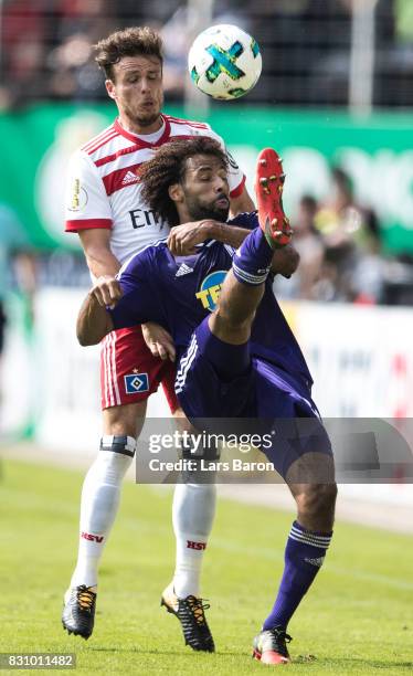 Nicolai Mueller of Hamburg challenges Nazim Sangare of Osnabrueck during the DFB Cup match between VfL Osnabrueck and Hamburger SV at Osnatel Arena...