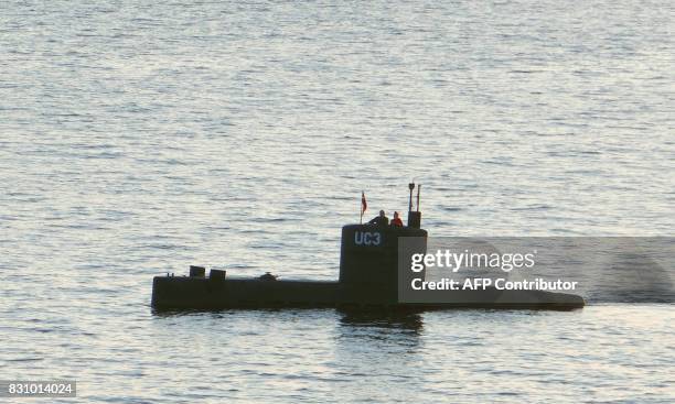 Allegedly Swedish journalist Kim Wall stands next to a man in the tower of the private submarine "UC3 Nautilus" on August 10, 2017 in Copenhagen...