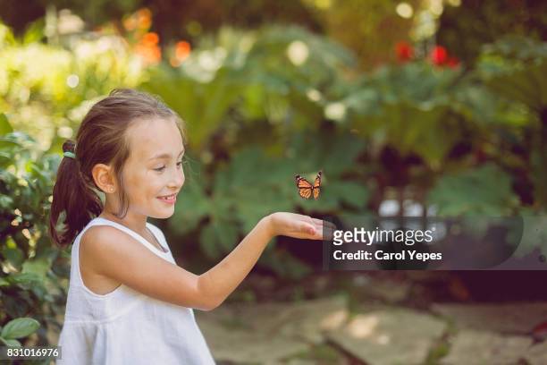 girl releasing a butterfly - butterfly effect stock-fotos und bilder