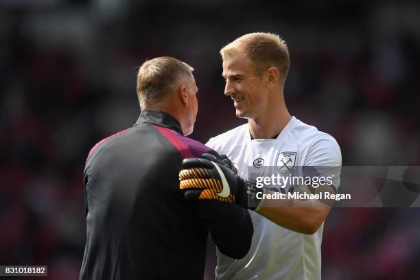 Joe Hart of West Ham United speaks to Chris Woods , West Ham United goalkeeper coach prior to the Premier League match between Manchester United and...