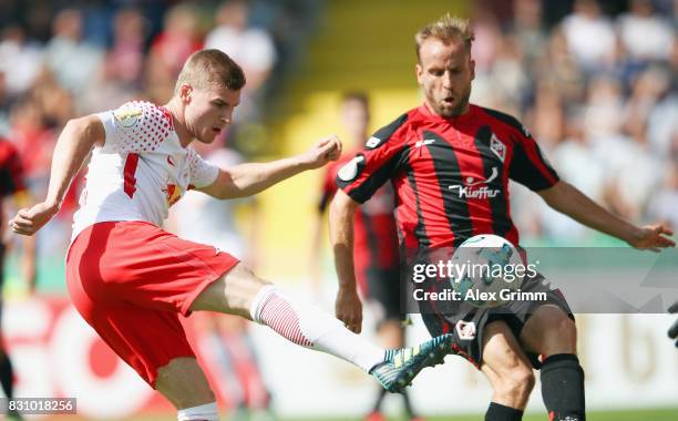 Timo Werner of Leipzig is challenged by Carl Murphy of Dorfmerkingen during the DFB Cup first round match between Sportfreunde Dorfmerkingen and RB...
