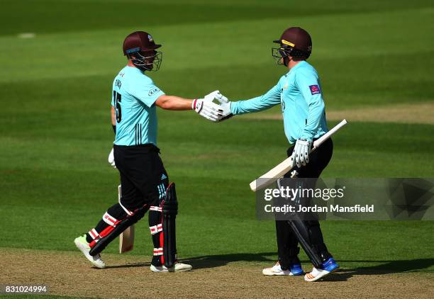 Jason Roy of Surrey celebrates his half-century with Aaron Finch of Surrey during the NatWest T20 Blast match between Surrey and Sussex Shark at The...