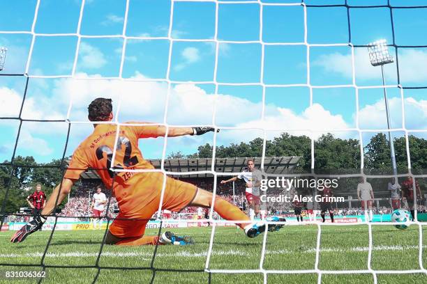 Yussuf Poulsen of Leipzig scores his team's fifth goal from the penalty spot against goalkeeper Christian Zech of Dorfmerkingen during the DFB Cup...