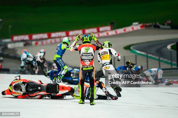 Forward Racing Team's Italian rider Lorenzo Baldassarri reacts after crashing in the first turn after start during the Moto2 Austrian Grand Prix race...