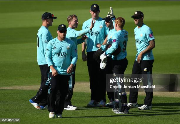 Gareth Batty of Surrey celebrates with his teammates after dismissing Ross Taylor of Sussex during the NatWest T20 Blast match between Surrey and...
