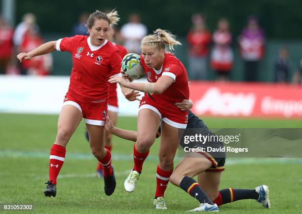 Emily Belchos of Canada is tackled by Elinor Snowsill of Wales during the Women's Rugby World Cup 2017 match between Canada and Wales on August 13,...