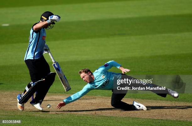 Gareth Batty of Surrey dives for a ball past Laurie Evans of Sussex during the NatWest T20 Blast match between Surrey and Sussex Shark at The Kia...