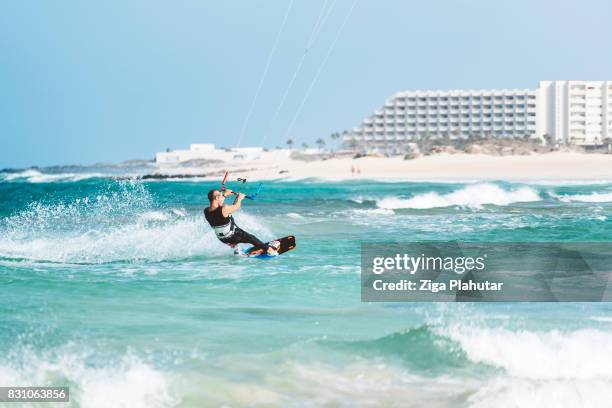 kiteboarder enjoying big waves and windy weather - slovenia beach stock pictures, royalty-free photos & images