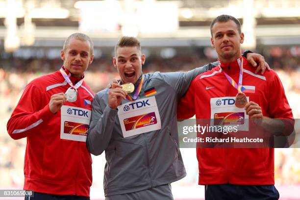 Jakub Vadlejch of the Czech Republic, silver, Johannes Vetter of Germany, gold, and Petr Frydrych of the Czech Republic, bronze, pose with their...