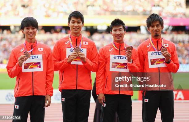 Shuhei Tada, Shota Iizuka, Yoshihide Kiryu and Kenji Fujimitsu of Japan, bronze, pose with their medals for the Men's 4x100 Metres Relay during day...
