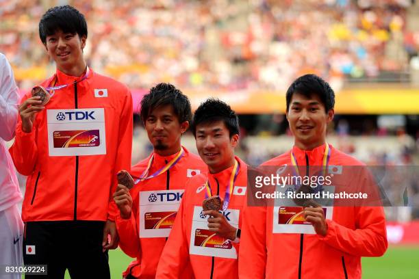 Shuhei Tada, Shota Iizuka, Yoshihide Kiryu and Kenji Fujimitsu of Japan, bronze, pose with their medals for the Men's 4x100 Metres Relay during day...