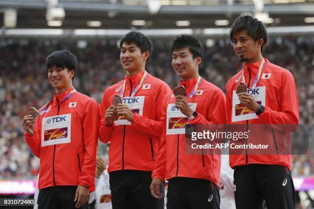 Bronze medallists Japanese team of Japan's Shuhei Tada, Shota Iizuka, Yoshihide Kiryu and Kenji Fujimitsu pose on the podium during the victory...