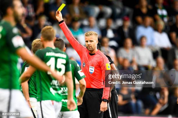 Referee Glenn Nyberg shown a yellow card during the Allsvenskan match between Jonkopings Sodra IF and Orebro SK at Stadsparksvallen on August 13,...
