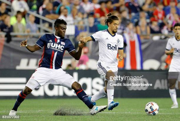 Vancouver Whitecaps midfielder Nicolas Mezquida moves away from New England Revolution midfielder Gershon Koffie during an MLS match between the New...
