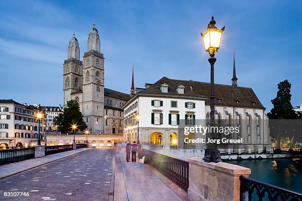 grossmuenster church, muenster bridge at dusk - switzerland zurich stock pictures, royalty-free photos & images