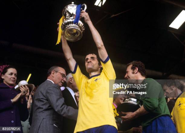 Arsenal captain Frank McLintock lifts the FA cup after Arsenal's victory over Liverpool in the 1971 FA cup final at Wembley Stadium, London.
