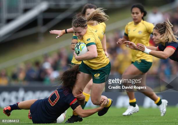 Samantha Treherne of Australia is tackled by Caroline Drouin and Marjorie Mayans of France during the Women's Rugby World Cup 2017 match between...