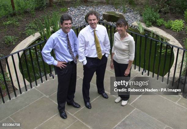 Britain's Prime Minister Tony Blair in front of the new Downing Street pond with the ponds designer Julie Toll and the director general of the...