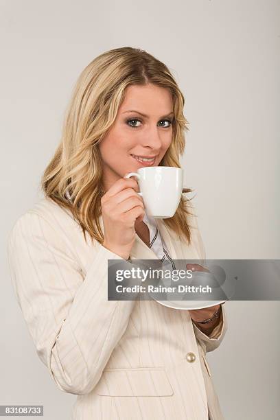 young woman drinking a cup of coffee, portrait - untertasse stock-fotos und bilder