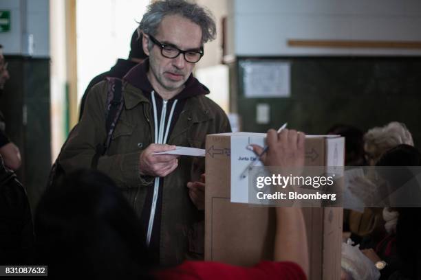 Voter casts a ballot at a polling center during a primary election in Buenos Aires, Argentina, on Sunday, Aug. 13, 2017. Argentinians are voting to...